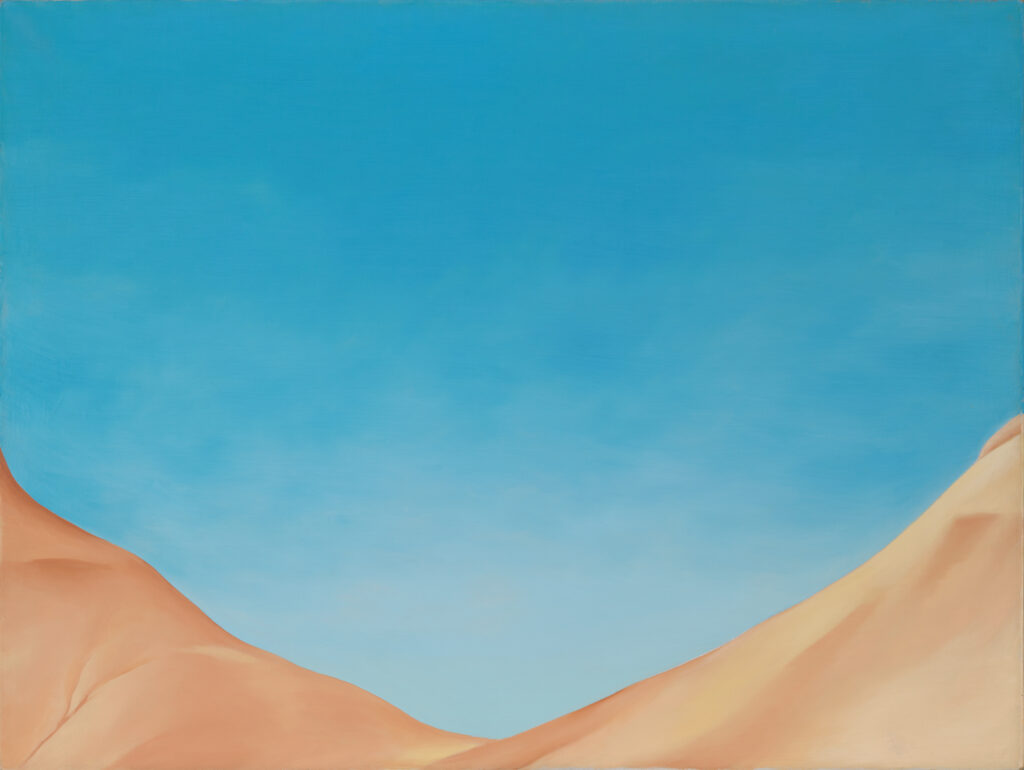 O'Keeffe describes this painting as " just the arms of two red hills reaching out to the sky holding it." This painting can be viewed as an organic abstraction contemplating the intersection of an expansive flat of blue sky and the V shape of the sandy red hills below.