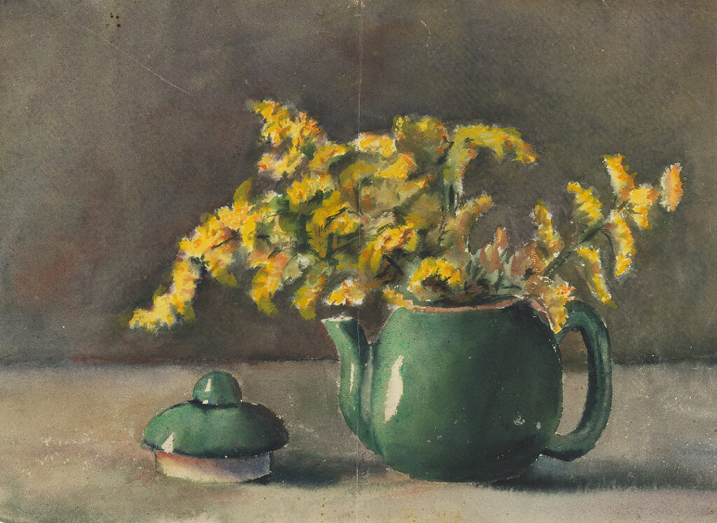 Watercolor study of green teapot with yellow flowers. The teapot is positioned on a flat surface slightly to the right of the center of the page, the yellow flowers are placed in the teapot, which serves as a makeshift vase. The teapot lid is lying to the left of the teapot. The background is done in a dark gray green and the flat surface in the foreground is a light tan color.