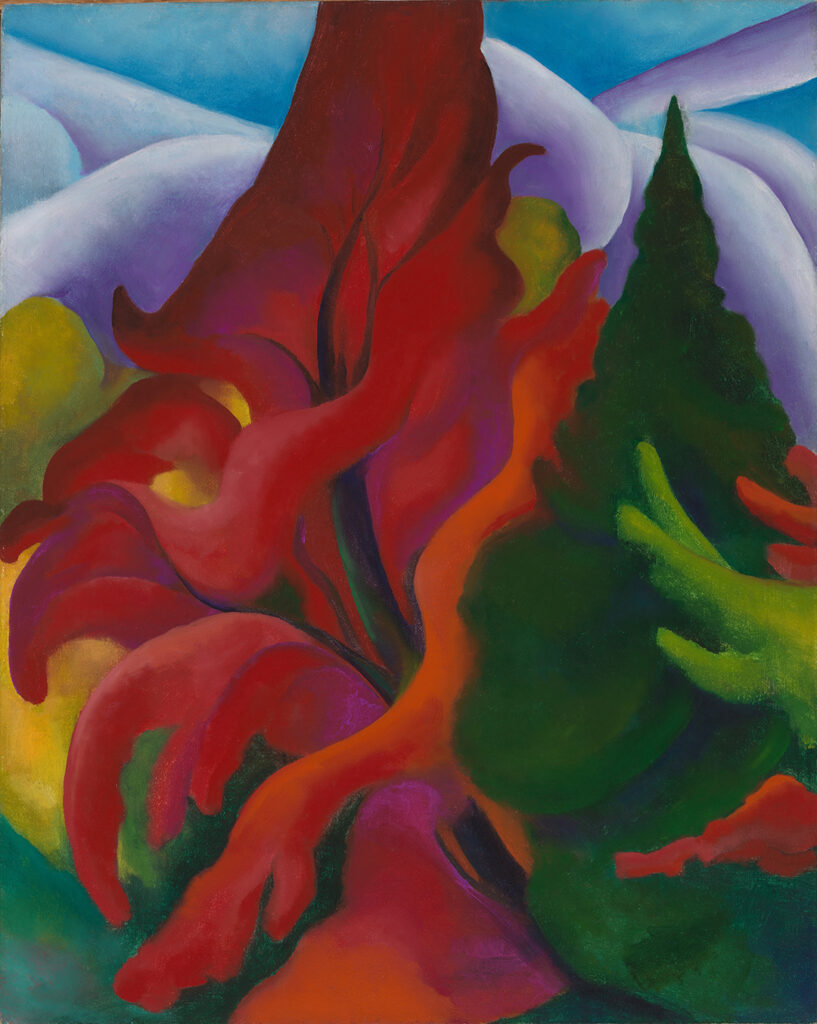 Vibrant canvas of large orange-red tree against purple-white hills and a blue sky. Surrounding the main red tree are areas of yellow color on the left and a green fir tree on the right.