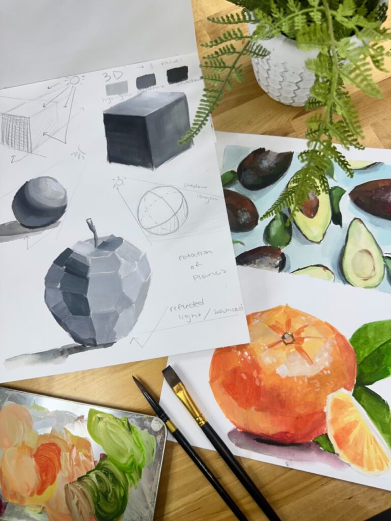 Two pieces of paper lay on a table with geometric paintings or fruit and studies of shadow. Around the paintings are a plant, a colorful paint palette, and several small brushes.