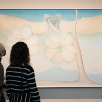 Two people looking up at a large painting