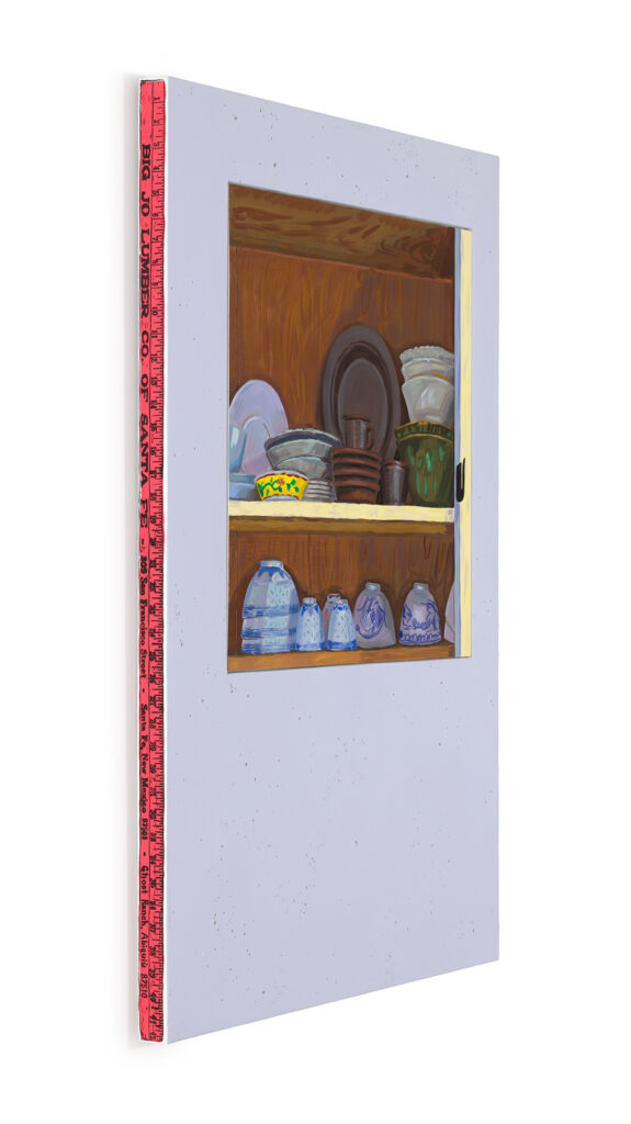 Image shows a painting from the side showing a yardstick screen printed in black on a red background. The painting has a lavender surround frames a painting in the upper two thirds of dishes on two shelves, one of the shelves is yellow, the other brown. The dishes are somewhat haphazardly placed against a brown background.
