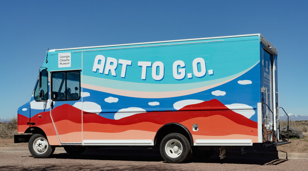 Image of a truck with mountain and cloud designs on it with the text 'Art to G.O.'