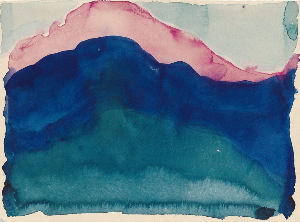 Horizontal watercolor of a deep blue rounded hill shape, echoed in pink directly above. The blue covers most of the paper, bleeding down to lighter hues towards the bottom. The pink is only a strip of color along the top, with the background filled by a pale blue wash.