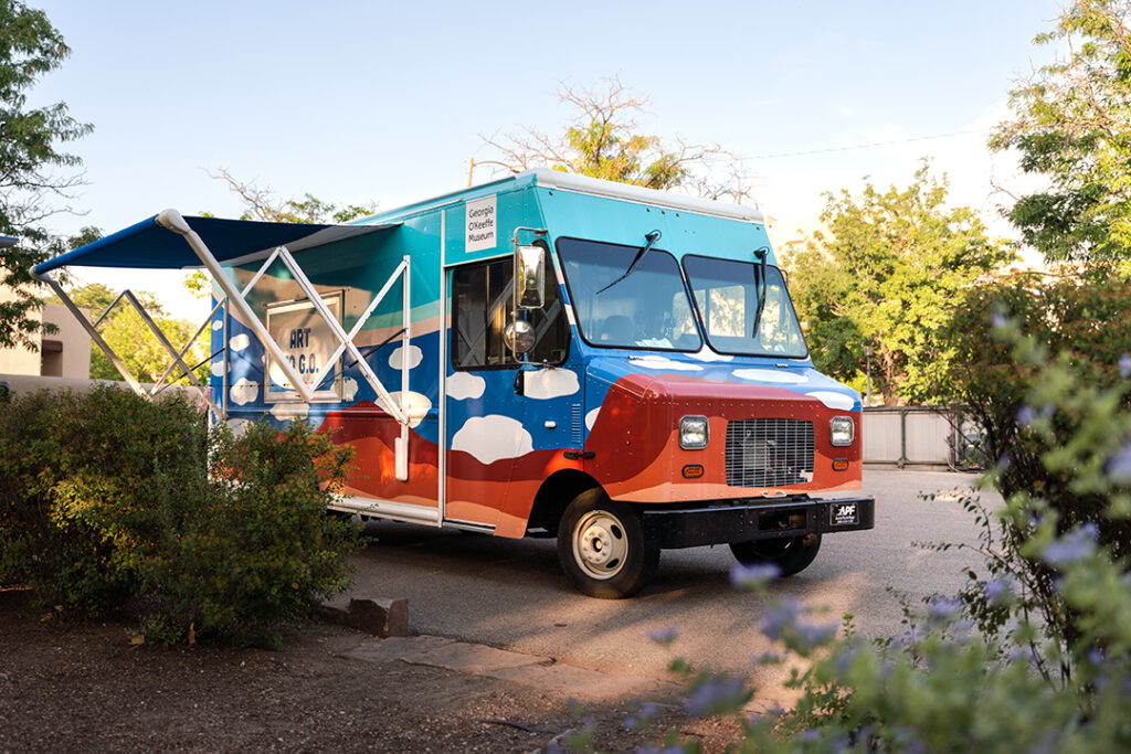 Photograph of the Art to G.O truck surrounded with a garden