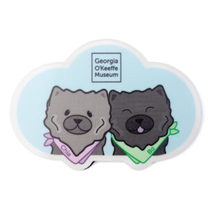 A magnet in the shape of a blue could with two illustrations of dark grey chow chow dogs wearing colorful bandanas marked Bo and Chia