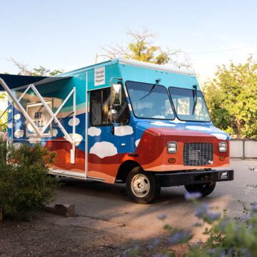 Photograph of the Art to G.O truck surrounded with a garden