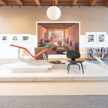 Two modern chairs on a platform with paper latern hanging overhead