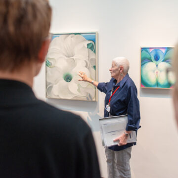 A docent leads a gallery talk.