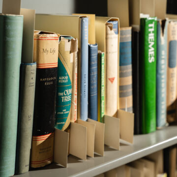 A close up shot of book spines in the O'Keeffe Museum Library and Archives. One title is visible titled "My Life".